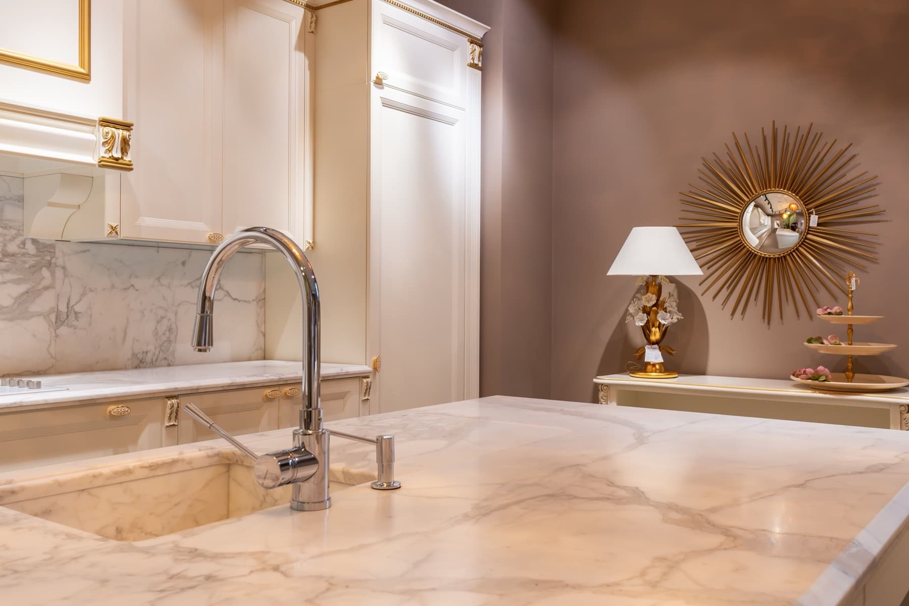 Luxury kitchen interior finished with polished marble countertops and backsplash